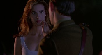 Movie still from “Hellraiser III: Hell on Earth” (1992), directed by Anthony Hickox – A woman looking in the mirror while a man looks at her face; Close Up shot, Over the shoulder angle