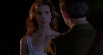 Movie still from “Hellraiser III: Hell on Earth” (1992), directed by Anthony Hickox – A woman standing next to a man in front of a dark background; Close Up shot, Over the shoulder angle