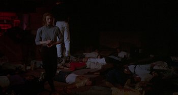 A group of people laying on the ground in a room