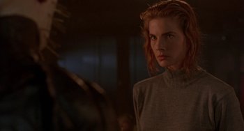 Movie still from “Hellraiser III: Hell on Earth” (1992), directed by Anthony Hickox – A woman with red hair is looking at the camera; Close Up shot, Over the shoulder angle