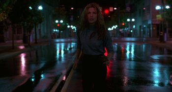Movie still from “Hellraiser III: Hell on Earth” (1992), directed by Anthony Hickox – A woman walking down a street at night; Medium shot, Low angle