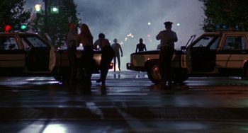 Movie still from “Hellraiser III: Hell on Earth” (1992), directed by Anthony Hickox – A group of people standing next to each other on a street; Wide shot, Low angle