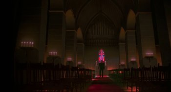 Movie still from “Hellraiser III: Hell on Earth” (1992), directed by Anthony Hickox – A man standing in front of a stained - glass window; Extreme Wide shot, Low angle