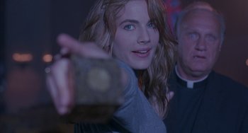 Movie still from “Hellraiser III: Hell on Earth” (1992), directed by Anthony Hickox – A beautiful young woman holding a camera in a room; Close Up shot, Over the shoulder angle