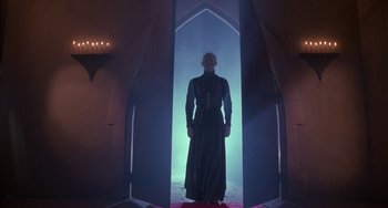 Movie still from “Hellraiser III: Hell on Earth” (1992), directed by Anthony Hickox – A man standing in a doorway in a dark room; Wide shot, Low angle