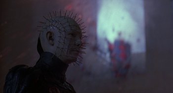Movie still from “Hellraiser III: Hell on Earth” (1992), directed by Anthony Hickox – A man with a pinhead head in front of a wall; Close Up shot, Low angle