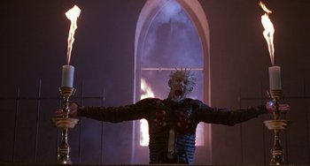 Movie still from “Hellraiser III: Hell on Earth” (1992), directed by Anthony Hickox – A person with a mask and a fire sword in front of a window; Medium shot, Low angle
