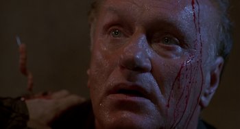 Movie still from “Hellraiser III: Hell on Earth” (1992), directed by Anthony Hickox – A person with blood on his face; Close Up shot, High angle