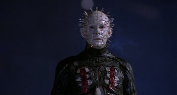 Movie still from “Hellraiser III: Hell on Earth” (1992), directed by Anthony Hickox – A man in a suit with a pinhead head; Close Up shot, Low angle