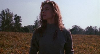 Movie still from “Hellraiser III: Hell on Earth” (1992), directed by Anthony Hickox – A woman with long hair standing in the middle of a field; Medium shot, Low angle