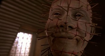 Movie still from “Hellraiser III: Hell on Earth” (1992), directed by Anthony Hickox – A person's face with a bunch of nails on it's face; Close Up shot, Low angle