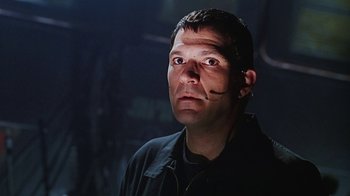 Movie still from “Hellraiser: Bloodline” (1996), directed by Kevin Yagher – A person wearing a black shirt; Close Up shot, Low angle