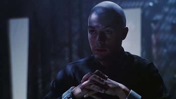 Movie still from “Hellraiser: Bloodline” (1996), directed by Kevin Yagher – A man with a bald head is looking at the camera; Close Up shot, Low angle