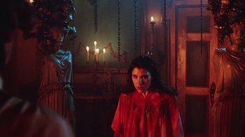 Movie still from “Hellraiser: Bloodline” (1996), directed by Kevin Yagher – A woman standing in a room next to candles; Medium shot, Over the shoulder angle