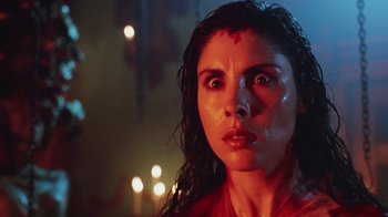 Movie still from “Hellraiser: Bloodline” (1996), directed by Kevin Yagher – A person with a candle in the background; Close Up shot, Low angle