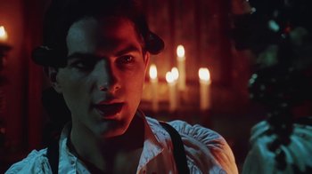 Movie still from “Hellraiser: Bloodline” (1996), directed by Kevin Yagher – A young man in a white shirt is in front of candles; Close Up shot, Over the shoulder angle