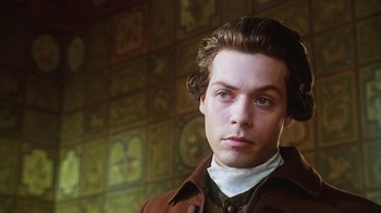 Movie still from “Hellraiser: Bloodline” (1996), directed by Kevin Yagher – A man in a brown jacket is standing in front of a wall; Close Up shot, Low angle