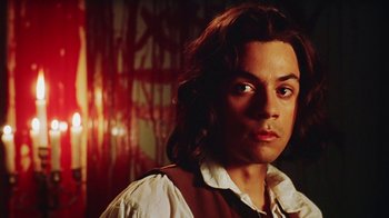 Movie still from “Hellraiser: Bloodline” (1996), directed by Kevin Yagher – A man with long brown hair wearing a white shirt; Close Up shot, Low angle