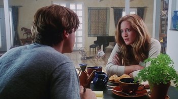 Movie still from “Hellraiser: Bloodline” (1996), directed by Kevin Yagher – A man and a woman sitting at a dining room table; Medium shot, Over the shoulder angle