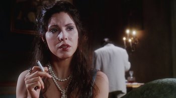 Movie still from “Hellraiser: Bloodline” (1996), directed by Kevin Yagher – A beautiful woman with long dark hair holding a cell phone; Close Up shot, Over the shoulder angle