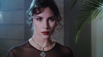 Movie still from “Hellraiser: Bloodline” (1996), directed by Kevin Yagher – A person wearing a necklace; Close Up shot, Over the shoulder angle