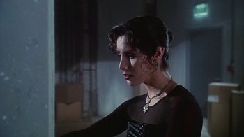 Movie still from “Hellraiser: Bloodline” (1996), directed by Kevin Yagher – A woman in a black dress looking to her left; Close Up shot, Over the shoulder angle