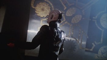 Movie still from “Hellraiser: Bloodline” (1996), directed by Kevin Yagher – A person in a black leather jacket and a mask; Medium shot, Low angle