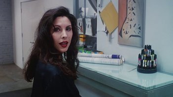 Movie still from “Hellraiser: Bloodline” (1996), directed by Kevin Yagher – A woman sitting in front of a painting on the wall; Close Up shot, High angle