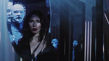 Movie still from “Hellraiser: Bloodline” (1996), directed by Kevin Yagher – A woman is standing in front of a mirror in a dark room; Close Up shot, Over the shoulder angle