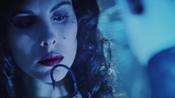 Movie still from “Hellraiser: Bloodline” (1996), directed by Kevin Yagher – A person wearing a red lipstick; Extreme Close Up shot, Overhead angle