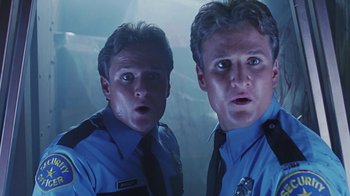 Movie still from “Hellraiser: Bloodline” (1996), directed by Kevin Yagher – Two police officers are looking surprised at the camera; Close Up shot, Low angle