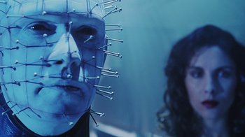 Movie still from “Hellraiser: Bloodline” (1996), directed by Kevin Yagher – A man's face in front of a woman's face; Close Up shot, Low angle