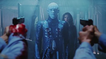Movie still from “Hellraiser: Bloodline” (1996), directed by Kevin Yagher – A man and a woman are standing next to each other; Medium shot, Low angle