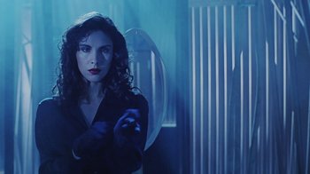 Movie still from “Hellraiser: Bloodline” (1996), directed by Kevin Yagher – A woman in a black shirt is holding something in her hand; Medium shot, Low angle