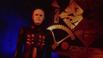 Movie still from “Hellraiser: Bloodline” (1996), directed by Kevin Yagher – A man in a costume with a knife in his hand; Medium shot, Low angle