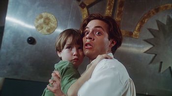 Movie still from “Hellraiser: Bloodline” (1996), directed by Kevin Yagher – A man and a boy are holding each other; Close Up shot, Low angle