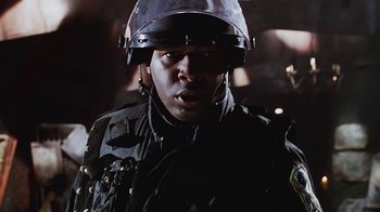 Movie still from “Hellraiser: Bloodline” (1996), directed by Kevin Yagher – A man wearing a helmet and a black jacket; Close Up shot, Low angle