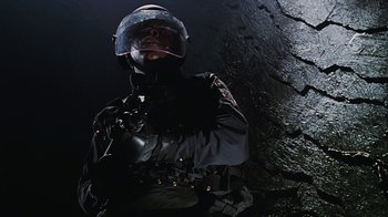 Movie still from “Hellraiser: Bloodline” (1996), directed by Kevin Yagher – A man in a police uniform is smoking a cigarette; Close Up shot, Low angle