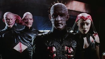 Movie still from “Hellraiser: Bloodline” (1996), directed by Kevin Yagher – A group of people standing next to each other in a room; Close Up shot, Low angle