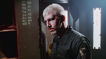 Movie still from “Hellraiser: Bloodline” (1996), directed by Kevin Yagher – A man with white hair is standing in a dark room; Close Up shot, Low angle