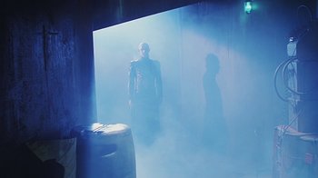 Movie still from “Hellraiser: Bloodline” (1996), directed by Kevin Yagher – A man standing in a room with smoke coming out of it; Wide shot, Low angle