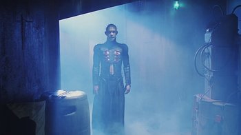 Movie still from “Hellraiser: Bloodline” (1996), directed by Kevin Yagher – A man dressed in a costume standing in a smoke filled room; Medium shot, Low angle
