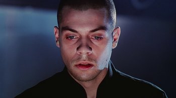 Movie still from “Hellraiser: Bloodline” (1996), directed by Kevin Yagher – A person wearing a black shirt; Close Up shot, Low angle