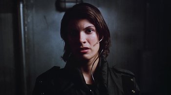 Movie still from “Hellraiser: Bloodline” (1996), directed by Kevin Yagher – A woman wearing a black jacket with headphones in her ears; Close Up shot, Low angle