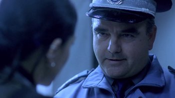 Movie still from “Hellraiser: Deader” (2005), directed by Rick Bota – A police officer talking to a woman in uniform; Close Up shot, Over the shoulder angle