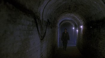 Movie still from “Hellraiser: Deader” (2005), directed by Rick Bota – A person walking through a tunnel with lights on; Wide shot, High angle