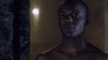 Movie still from “Hellraiser: Deader” (2005), directed by Rick Bota – A man with no shirt is looking at the camera; Close Up shot, Low angle
