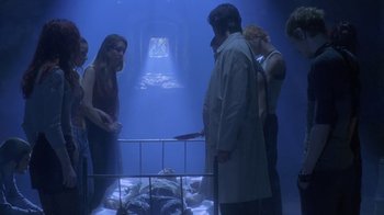 Movie still from “Hellraiser: Deader” (2005), directed by Rick Bota – A group of people standing around a dead body; Wide shot, High angle