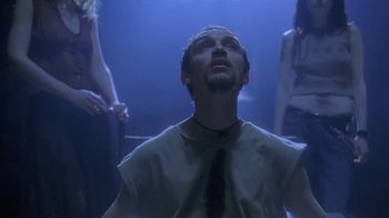 Movie still from “Hellraiser: Deader” (2005), directed by Rick Bota – A man in a tie looking up into the sky; Medium shot, Low angle