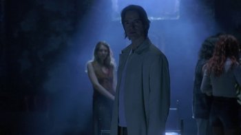 Movie still from “Hellraiser: Deader” (2005), directed by Rick Bota – A man and a woman standing in a dark room; Medium shot, Low angle